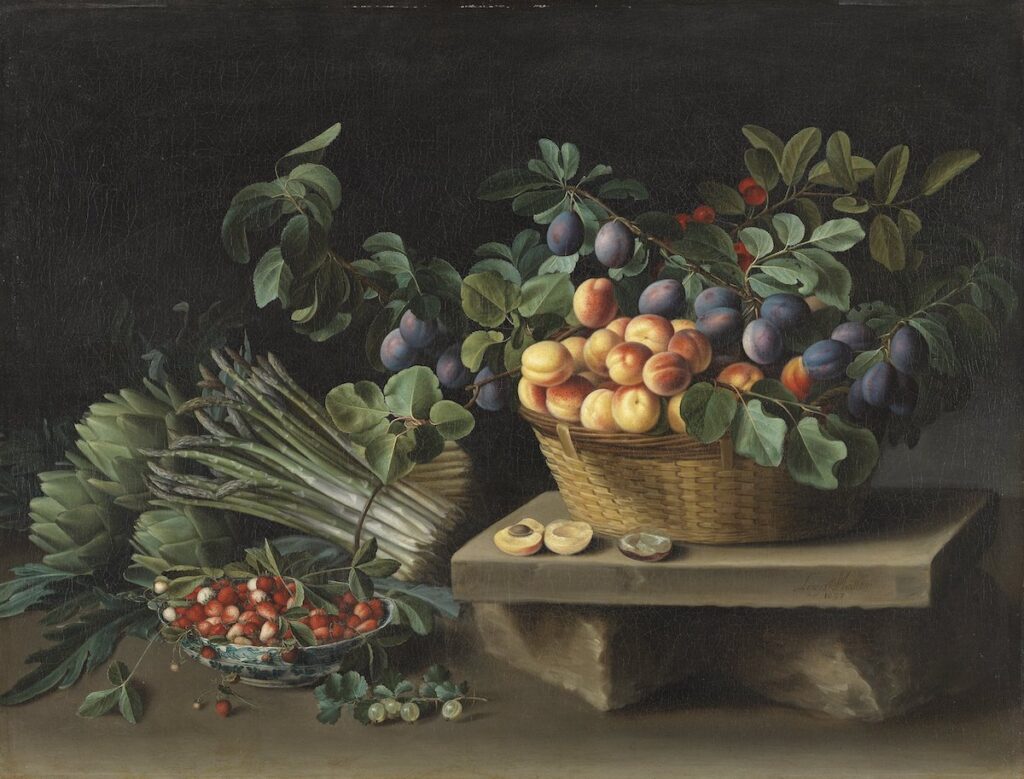 In this rectangular, landscape mode fruit still life, a close-weaved oblong wicker basket sits on a wooden or stone block. The basket contains apricots, plums, and a small red fruit, possibly cherries. There are branches with green leaves among the fruits. In front of the basket on the back are some halved apricots. To the left of the block are artichokes, a bunch of asparagus, strawberries in white and blue porcelain bowl, and a small branch of gooseberries.