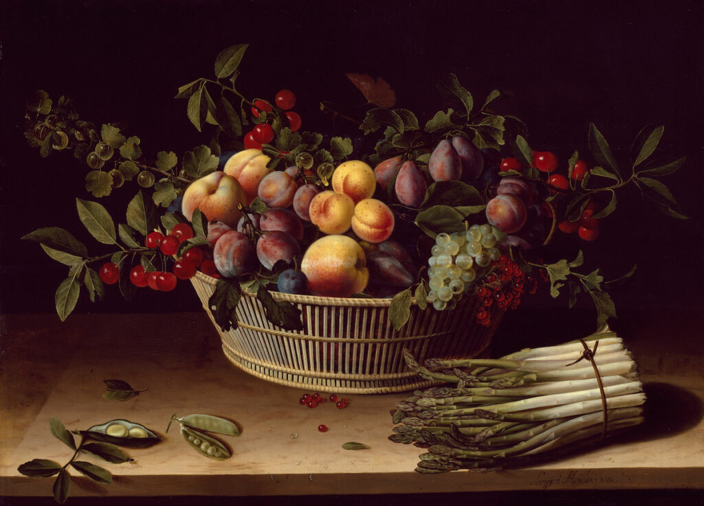 A lush scene with an openwork oblong wicker basket full of peaches, apricots, gooseberries, cherries, plums, and grapes, with leafy branches inserted at the sides and back. In front of the basket, on a wooden table or ledge, sit on the left two open pea pods and one closed peeped; and on the right, a bunch of about 20 asparagus spears, tied with a cord.