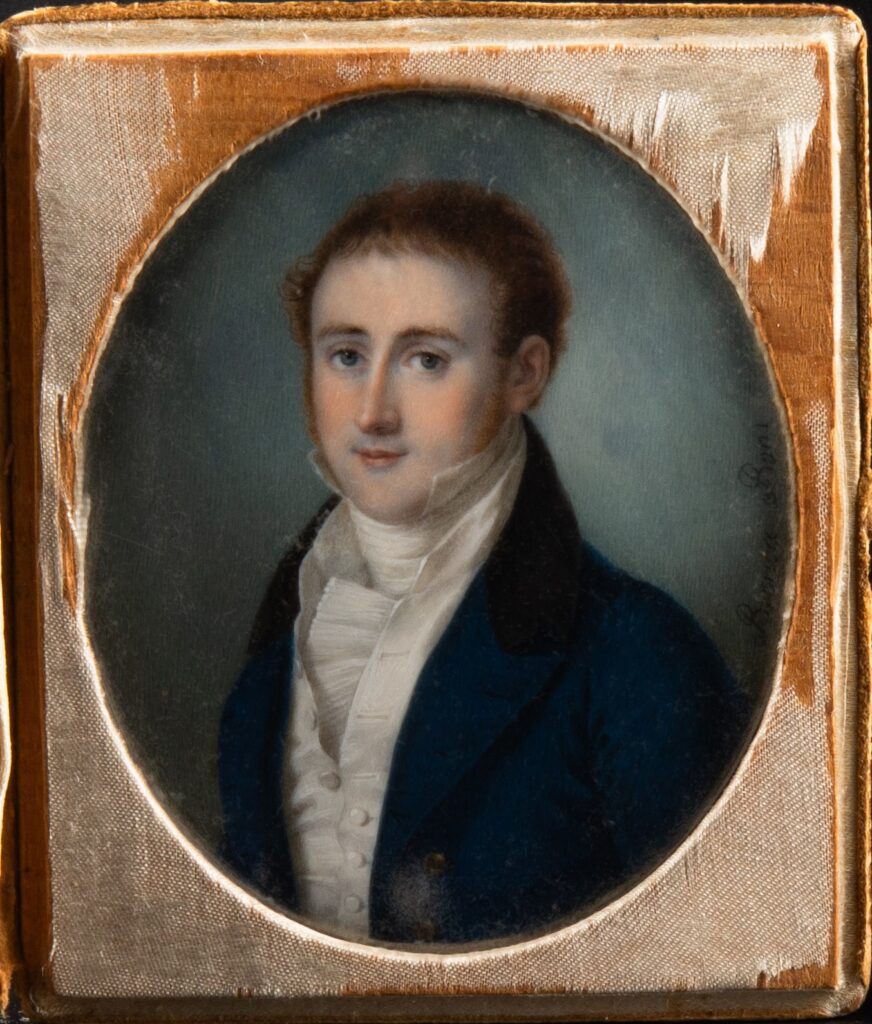 A miniature painting of a man in a white shirt and waistcoat and a black jacket, in a square frame with an oval opening.